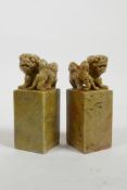 A pair of Chinese soapstone seals with carved fo dog knops, one seal blank, 4½" high