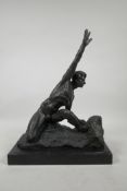 A patinated bronze of an athletic male nude, 11" wide, 14" high