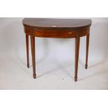 A C19th mahogany demilune card table with a crossbanded top on tapestry supports, 36" x 17½", 29"