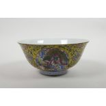 A Chinese polychrome porcelain bowl with decorative panels depicting a dragon and phoenix, the