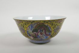 A Chinese polychrome porcelain bowl with decorative panels depicting a dragon and phoenix, the