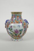 A Chinese polychrome enamelled porcelain vase with two mark and loop handles, with decorative panels