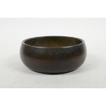 A Chinese bronze Buddhist singing bowl, impressed seal mark to base, 5½" diameter