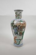 A Chinese famille verte porcelain vase decorated with noblemen in an interior, six character mark to