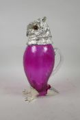 A glass and silver plate claret jug in the form of an owl with glass set eyes, 11" high