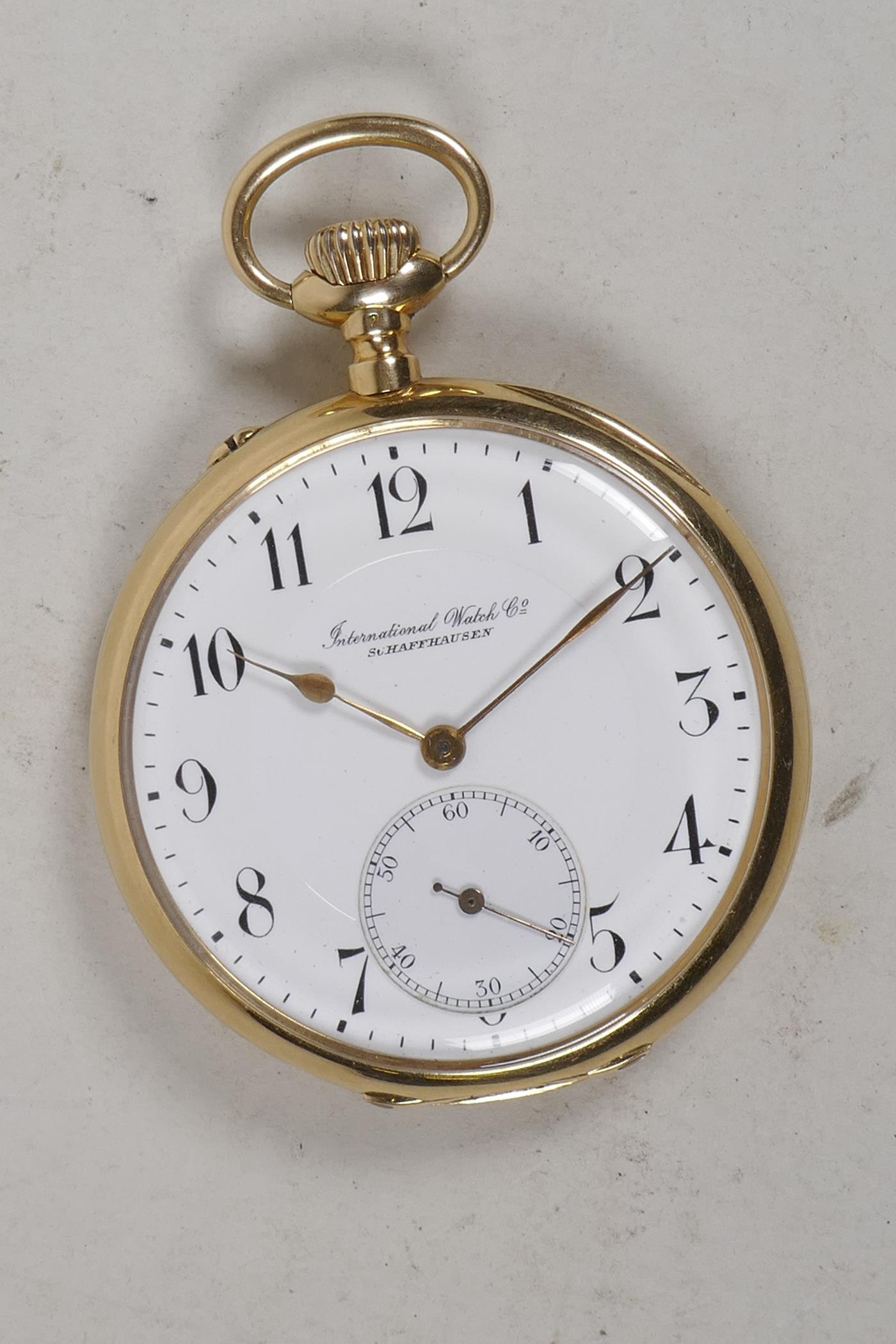 An International Watch Company 14ct gold cased open face pocket watch having white enamel face