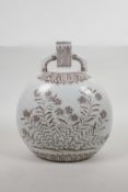 A Chinese blue and white porcelain two handled moon flask with floral decoration, 10" high