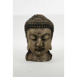 An oriental carved and painted Buddha head, 9½" high