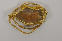 A gilt metal brooch set with a flint burin, 3" x 2½"