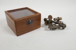 A cased reproduction brass sextant, 5" x 5"