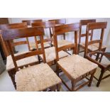 A set of eight rush seated fruitwood chairs with applied Dixy maker's plaque