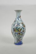 A Chinese doucai porcelain vase decorated with a fruiting peach tree and bats, six character mark to