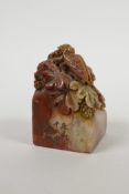 A Chinese chicken blood soapstone seal with carved cicada decoration, 2" x 2" x 3" high