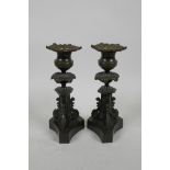 A pair of bronze tri-form candle sticks, 7" high