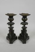 A pair of bronze tri-form candle sticks, 7" high