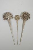 Three Chinese silvered metal hairpins with floral and peacock decoration, impressed character marks,