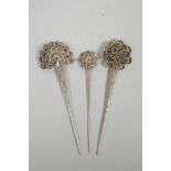 Three Chinese silvered metal hairpins with floral and peacock decoration, impressed character marks,