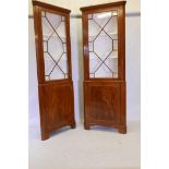 A good pair of Regency style figured mahogany corner display cabinets, the tops with astragal glazed