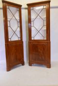 A good pair of Regency style figured mahogany corner display cabinets, the tops with astragal glazed