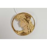A 925 silver gilt Art Nouveau style brooch decorated with a lady in a hat, 1½" diameter