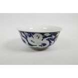 A Chinese blue and white rice bowl with raised dragon decoration, six character mark to base, 6"