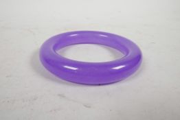 A reconstituted and dyed jade bangle, 3½" diameter