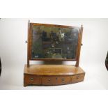A Victorian mahogany swing toilet mirror on bow feet, three drawer base and reeded supports, A/F,