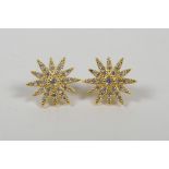 A pair of silver gilt car studs in the form of stars set with cubic zirconium