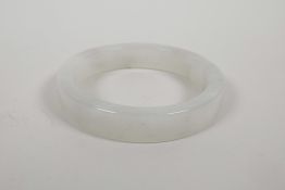 A Chinese white mottled hardstone bangle, 2½" interior diameter