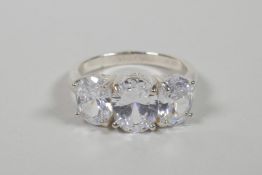 A 925 silver and cubic zirconium set three stone ring, approximate size 'R'