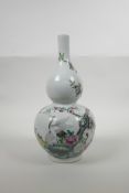 A Chinese double gourd porcelain vase with polychrome enamelled decoration of cranes amongst a peach