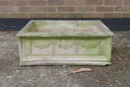 A reconstituted stone garden trough with floral spray decoration, 20½" x 26"