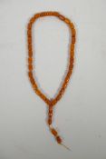 A string of faux amber prayer beads, 22" long