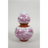 A Chinese porcelain double gourd vase with pink enamel river landscape decoration, seal mark to