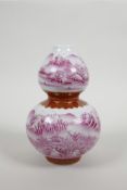 A Chinese porcelain double gourd vase with pink enamel river landscape decoration, seal mark to