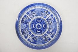 A Chinese blue and white plate with chrysanthemum decoration around a central roundel depicting four