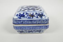 A Chinese blue and white porcelain box and cover with dragon decoration, 7" x 7"