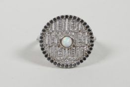 A 925 silver and cubic zirconium encrusted ring set with a central opal, approximate size P/Q