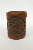 A Chinese carved bamboo brush pot decorated with figures in a landscape, 6½" high