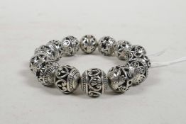 A Chinese pierced white metal beaded bracelet, 3" diameter