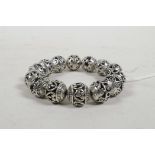 A Chinese pierced white metal beaded bracelet, 3" diameter