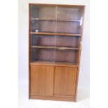 A Danish 1970s Herbert Elsibb Teak bookcase with glass doors, 36" x 11" x 68" high