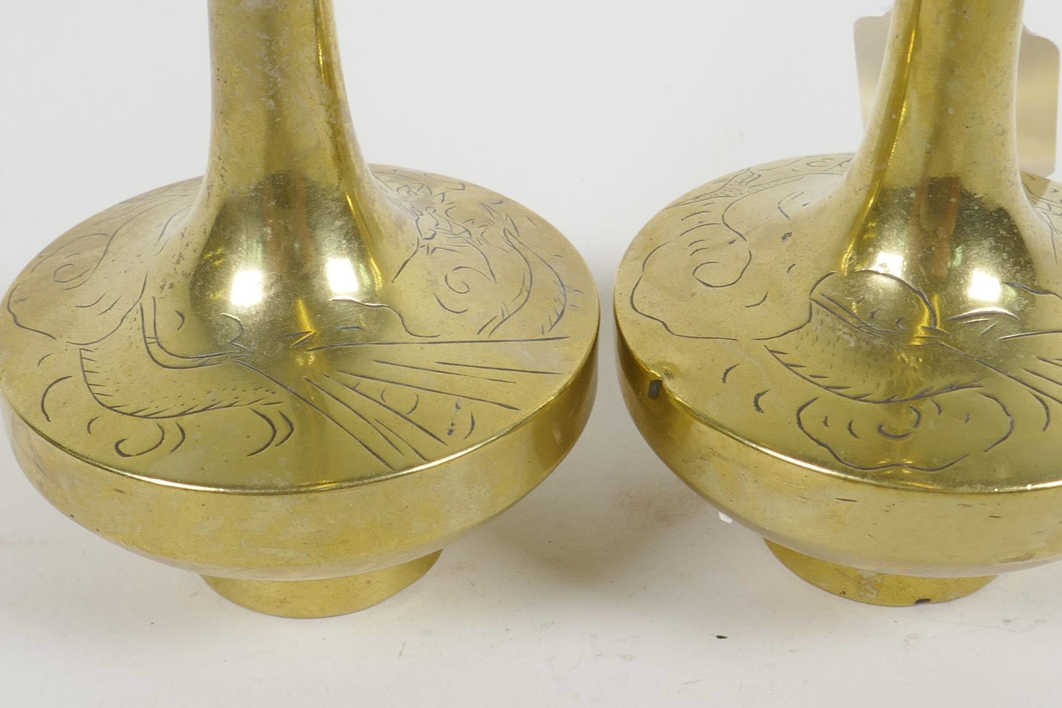 A pair of Chinese brass long necked specimen vases having engraved decoration of dragons, 8½" high - Image 2 of 3