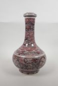 A Chinese porcelain bottle vase with red and black stylised linear kylin decoration, six character