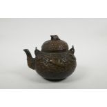 A Chinese bronze teapot with raised decoration of cranes in flight, four character mark to base, 5½"