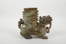 A Chinese green and grey mottled hardstone spill vase carved in the form of a kylin, 6½" high