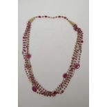 A ruby and silver gilt multi-strand necklace, 26" long
