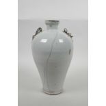 A Chinese white crackle glazed pottery vase with two dragon shaped handles, 9½" high