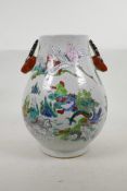 A Chinese famille verte pottery vase with two deer mask handles, and decorated with immortals and