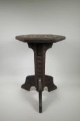 A Burmese carved hardwood hexagonal top wine table on tripod supports, 15" x 13" x 20½" high